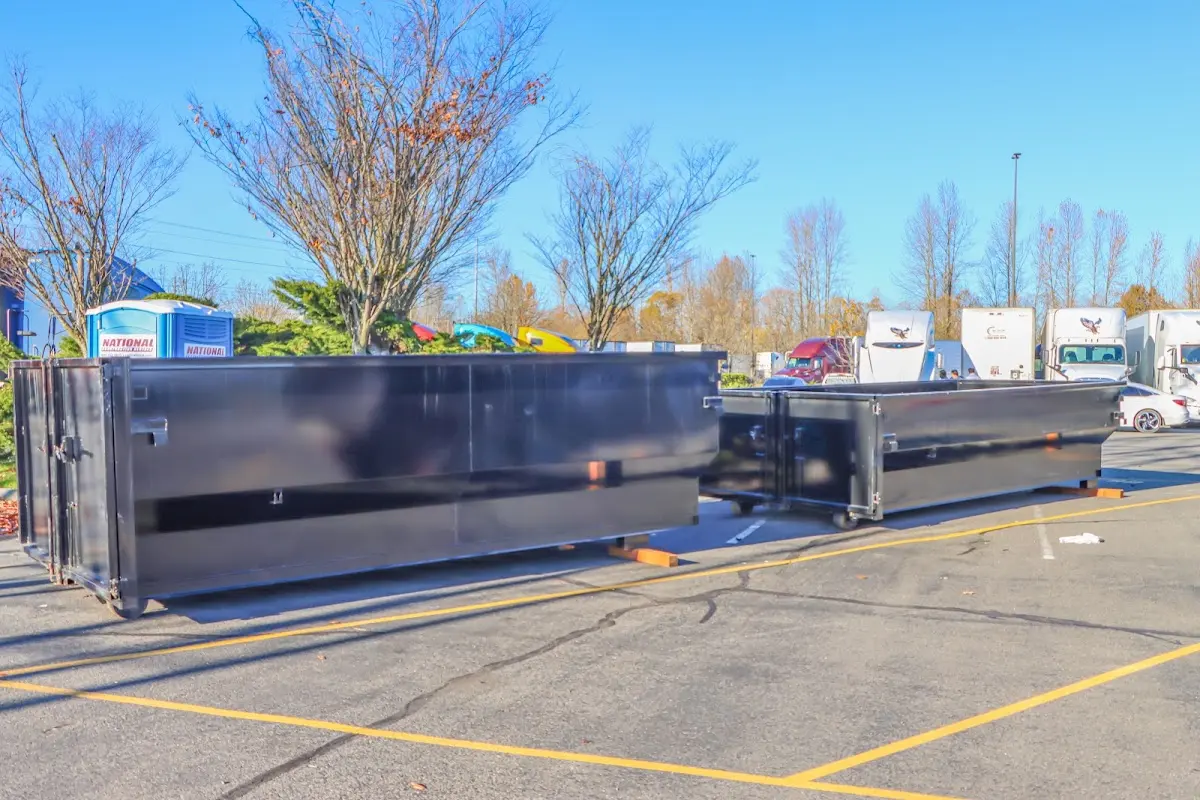 Professional dumpster rental service with roll-off container on residential driveway in Nixa
